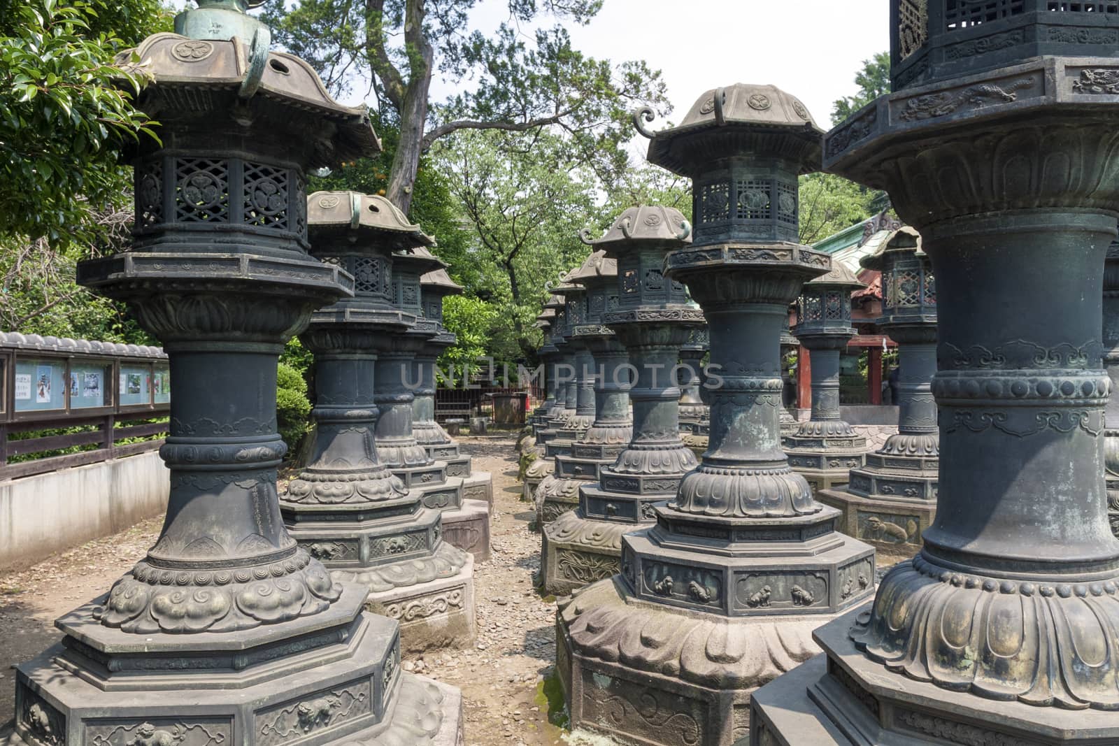 Rows of traditional stone lanterns in Tokyo Ueno park