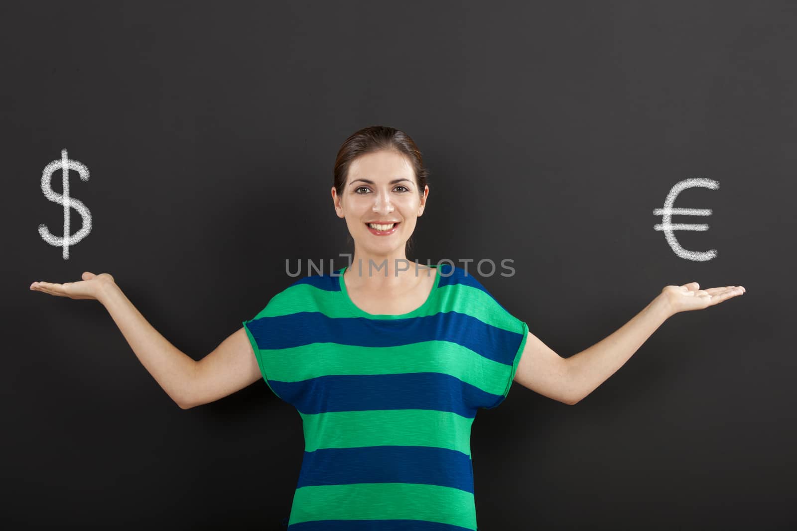 Happy woman in front of a chalkboard ilustrating a concept about money currency 