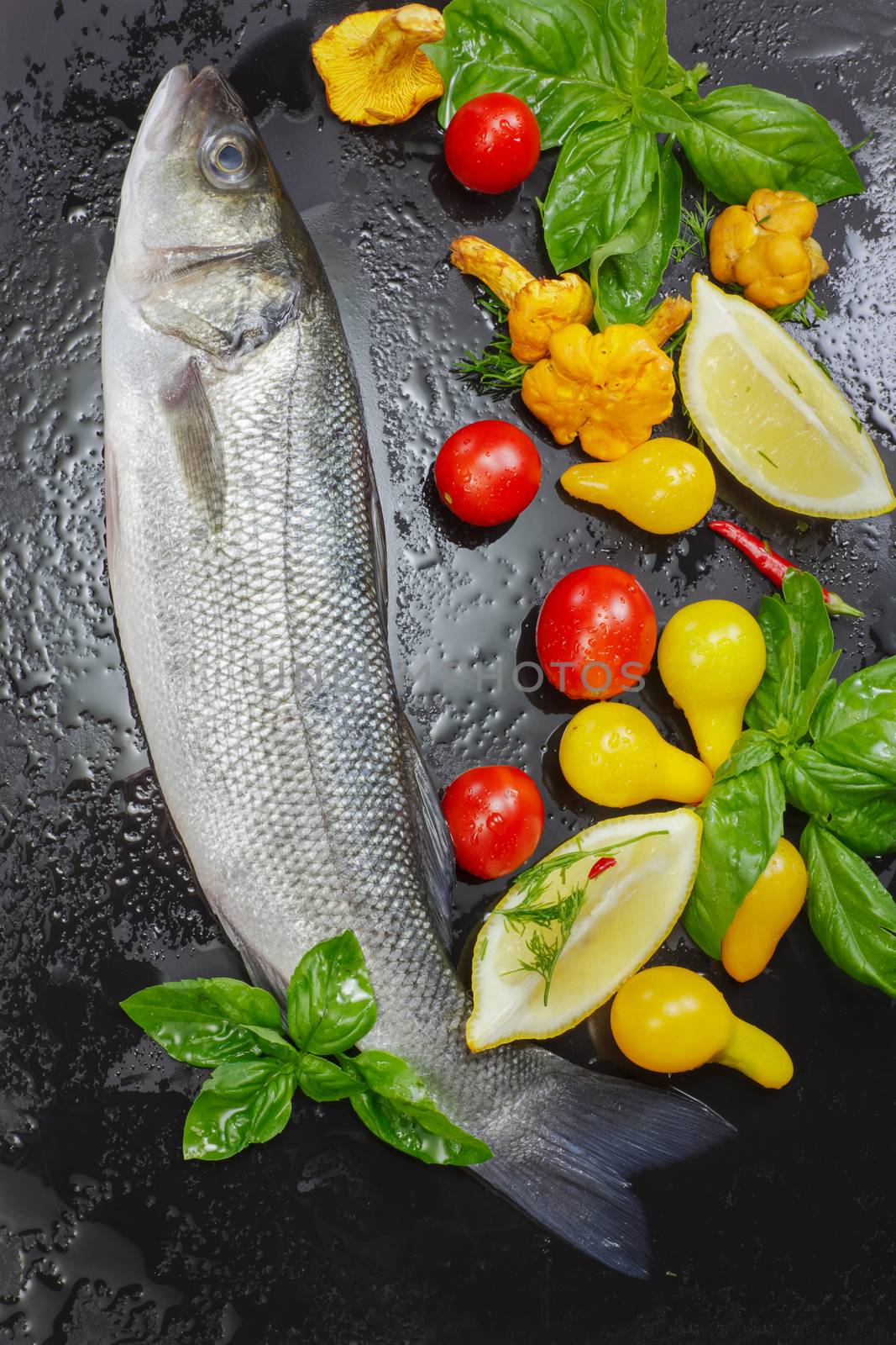 Raw sea fish with chanterelles, lemon, vegetable and basil.  Preparing food