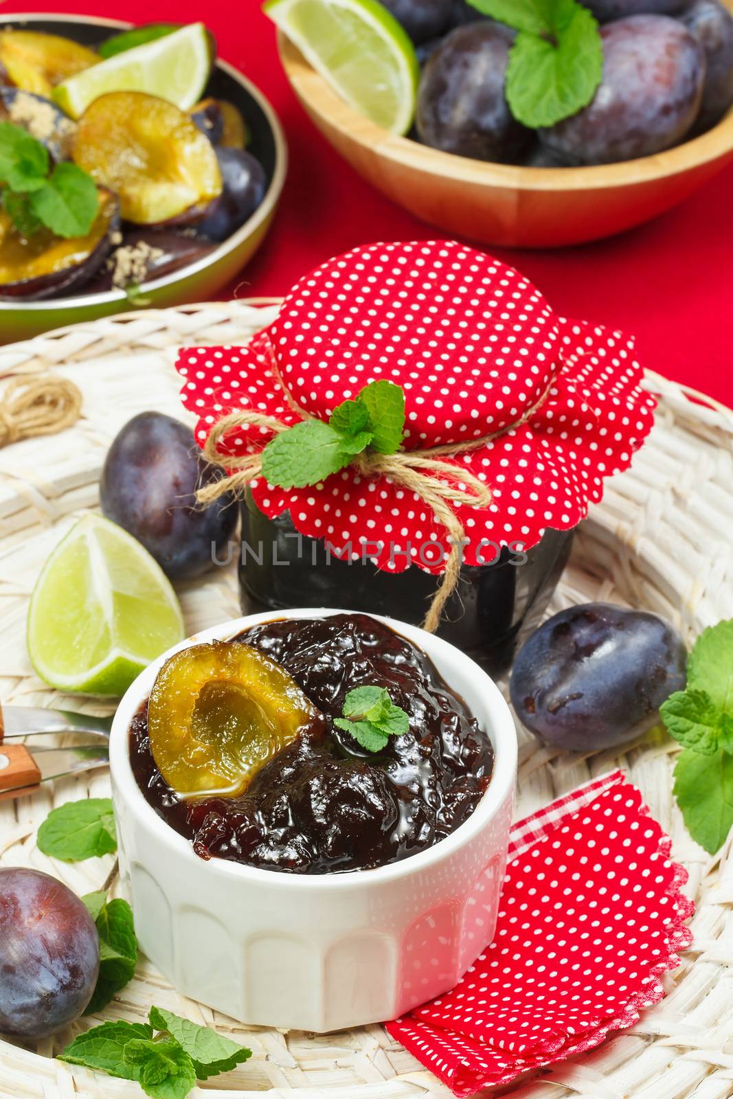 Plum jam and fresh fruits with leaves. Done with a vintage retro filter. Preparing food