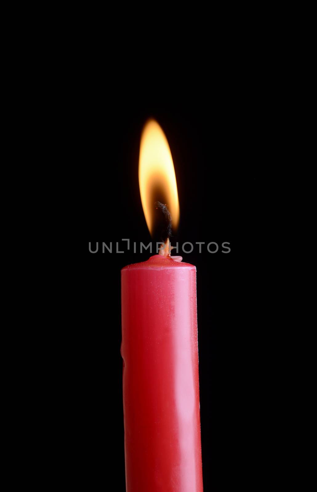red candle in front of black background