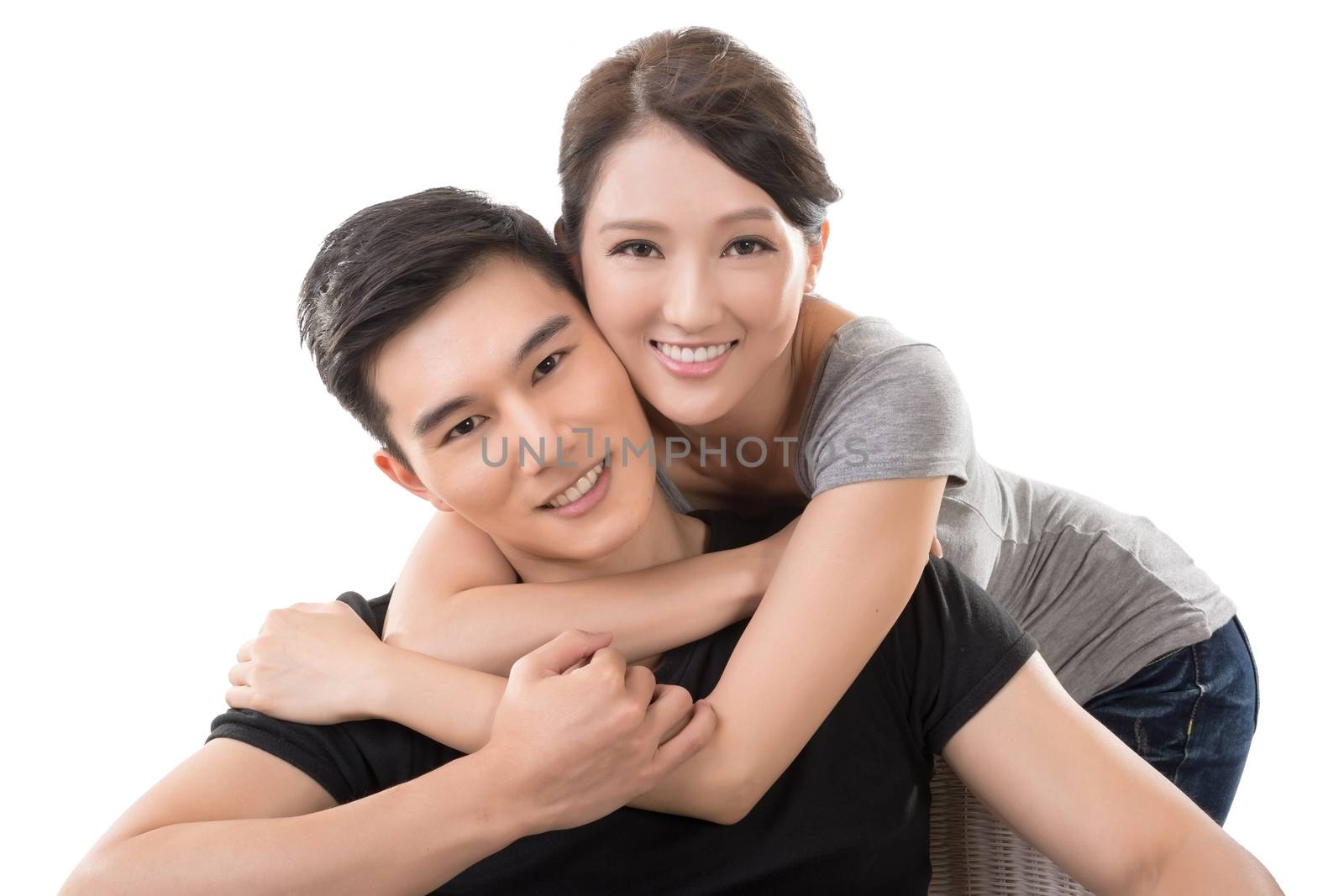 Attractive young Asian couple, closeup portrait on white.