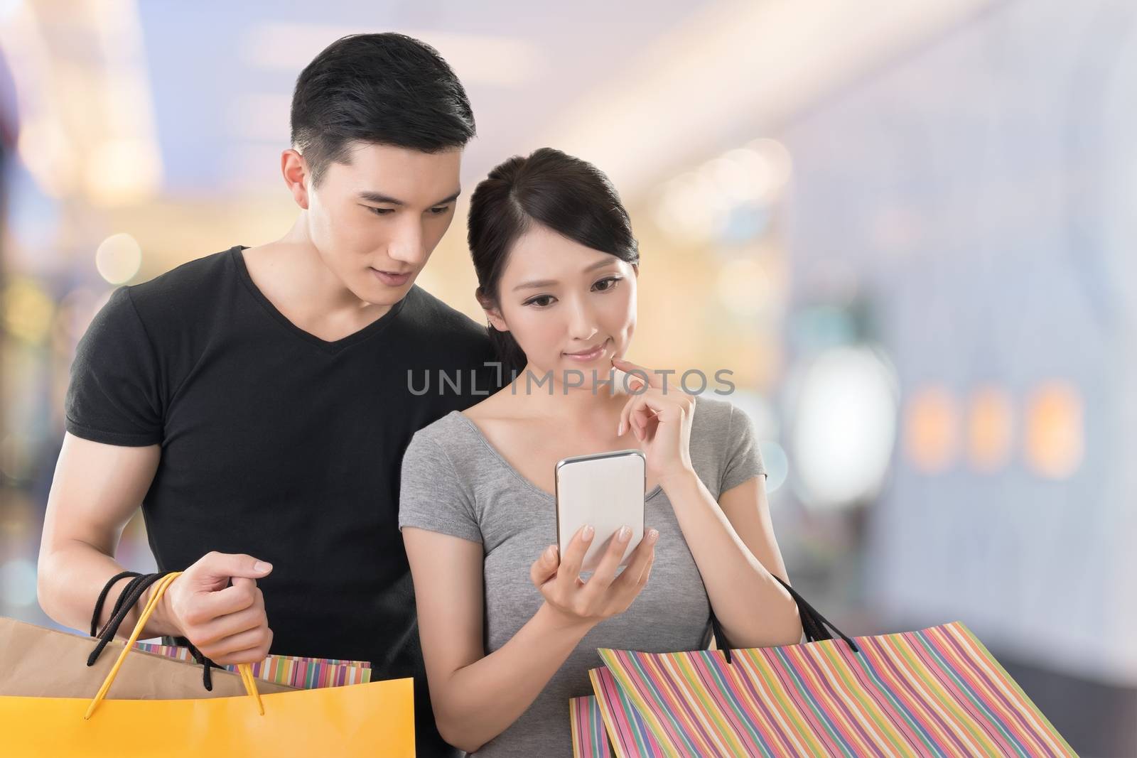shopping and looking at cellphone by elwynn