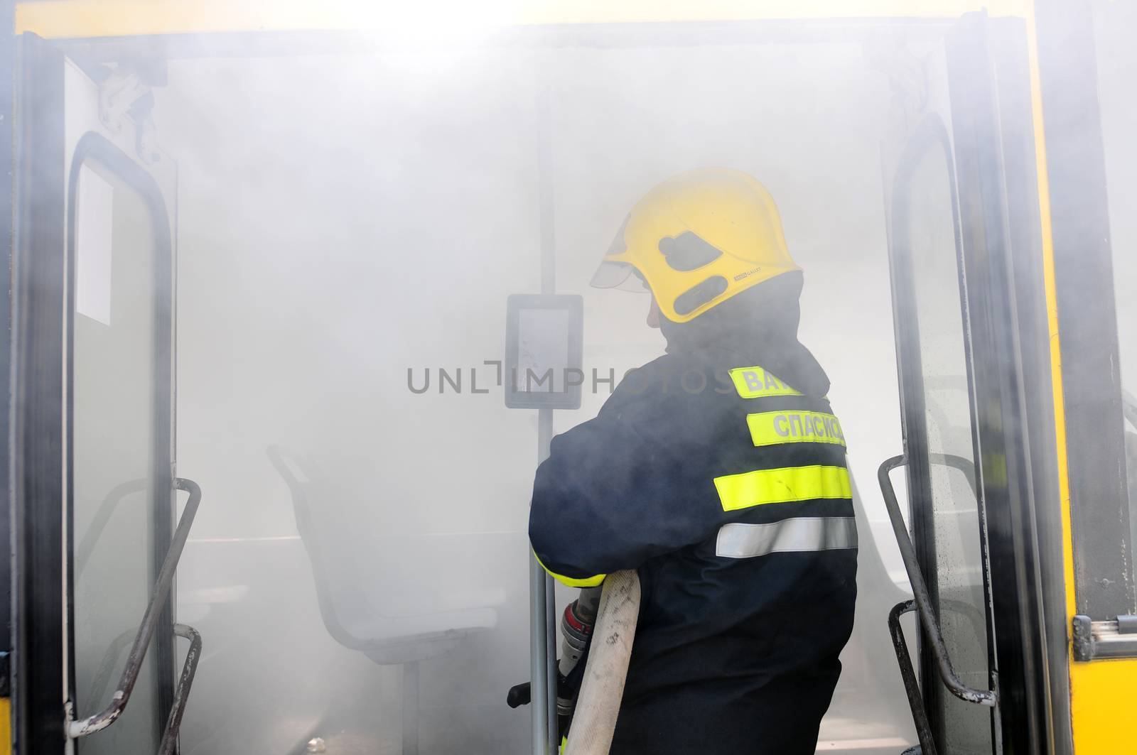 SERBIA, BELGRADE - APRIL 27, 2012: Fire fighters tries to extinguish burning bus on the street