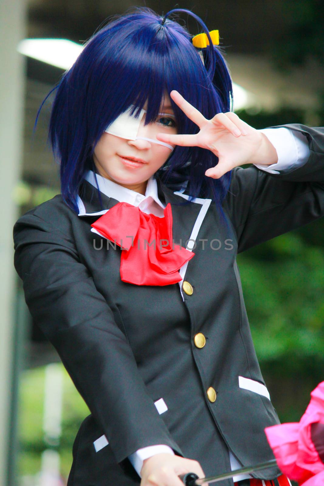 Bangkok - Aug 31: An unidentified Japanese anime cosplay Takanashi Rikka pose  on August 31, 2014 at Central World, Bangkok, Thailand.