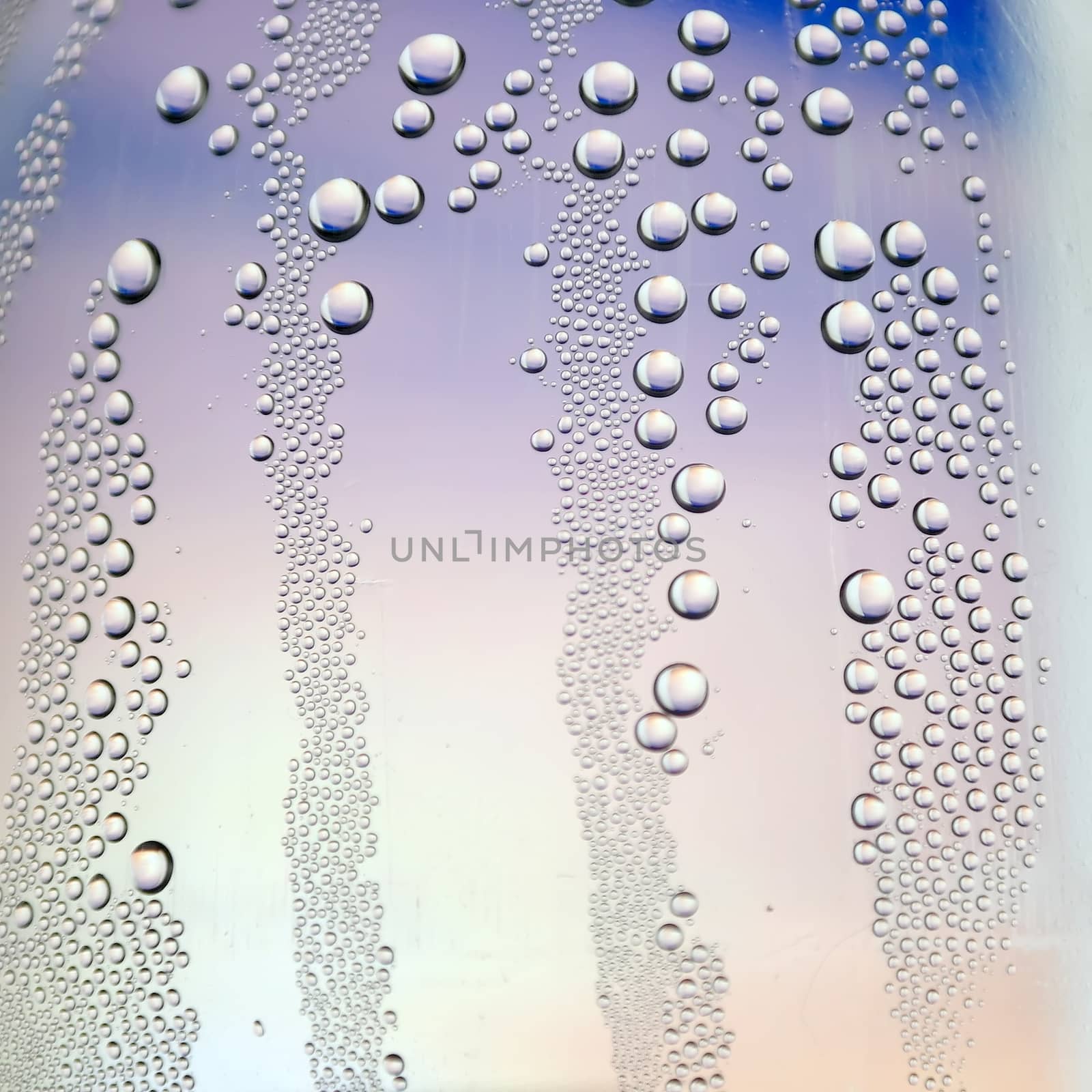 Abstract background. Drops of water on the crooked glass, shallow dof