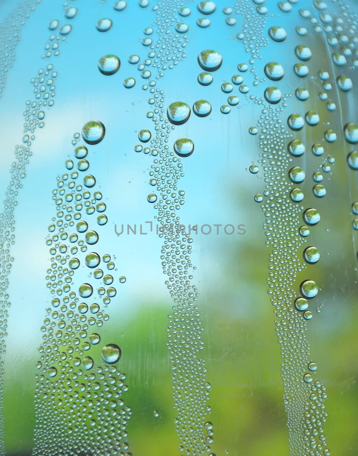 Abstract background. Drops of water on the crooked glass, shallow dof