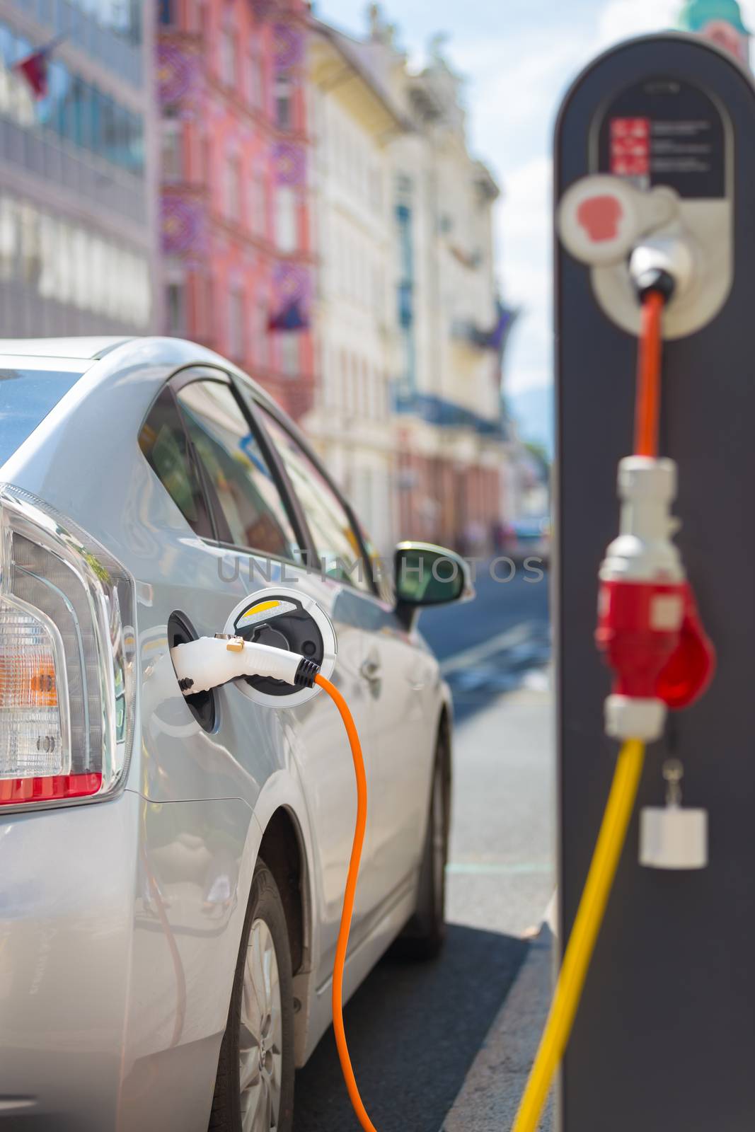 Electric Car in Charging Station. by kasto