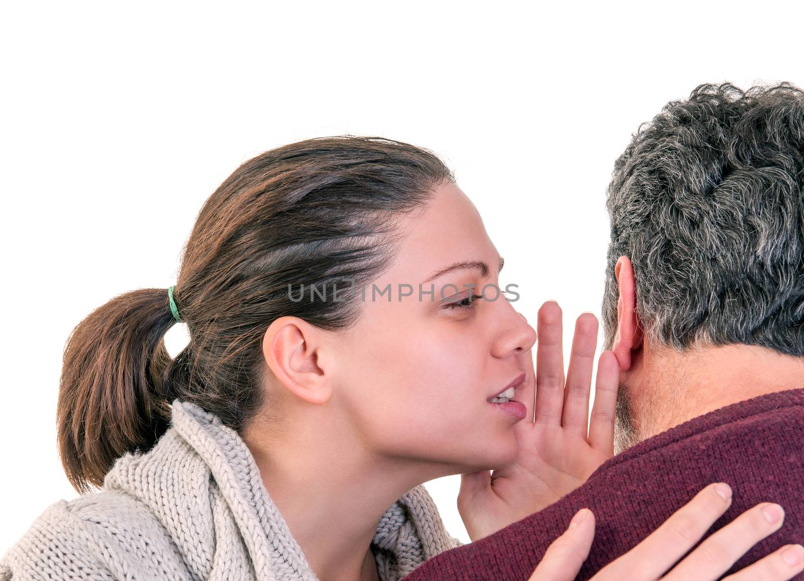 Young woman side portrait speaking in the ear of mature man showing from behind, horizontal shot over white