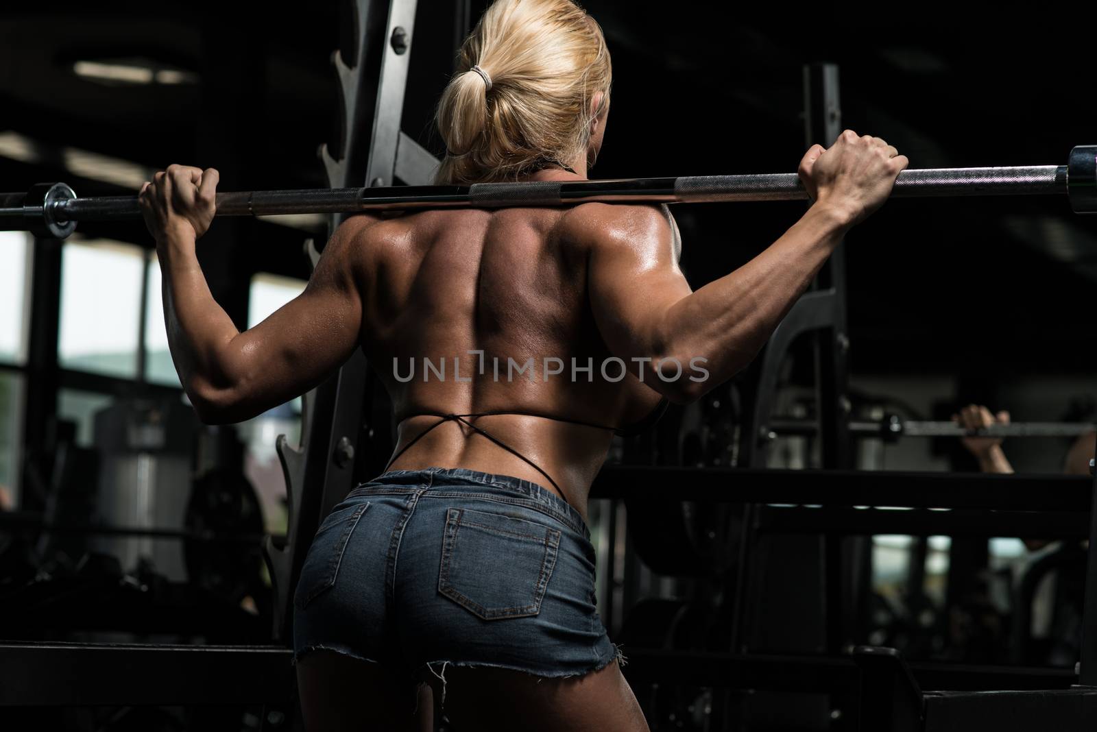 Woman Doing Squat Workout For Legs by JalePhoto
