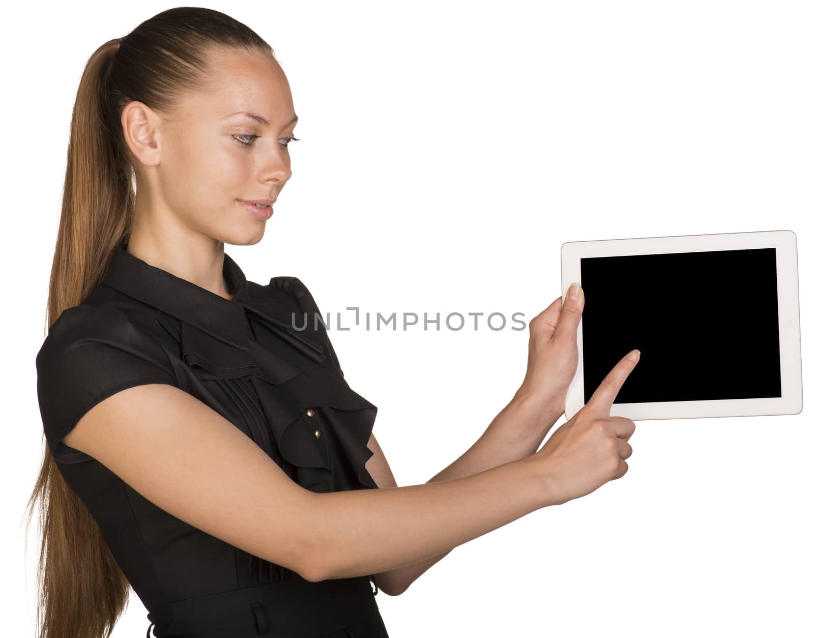 Beautiful girl in dress holding tablet and pointing at screen. Isolated on white background