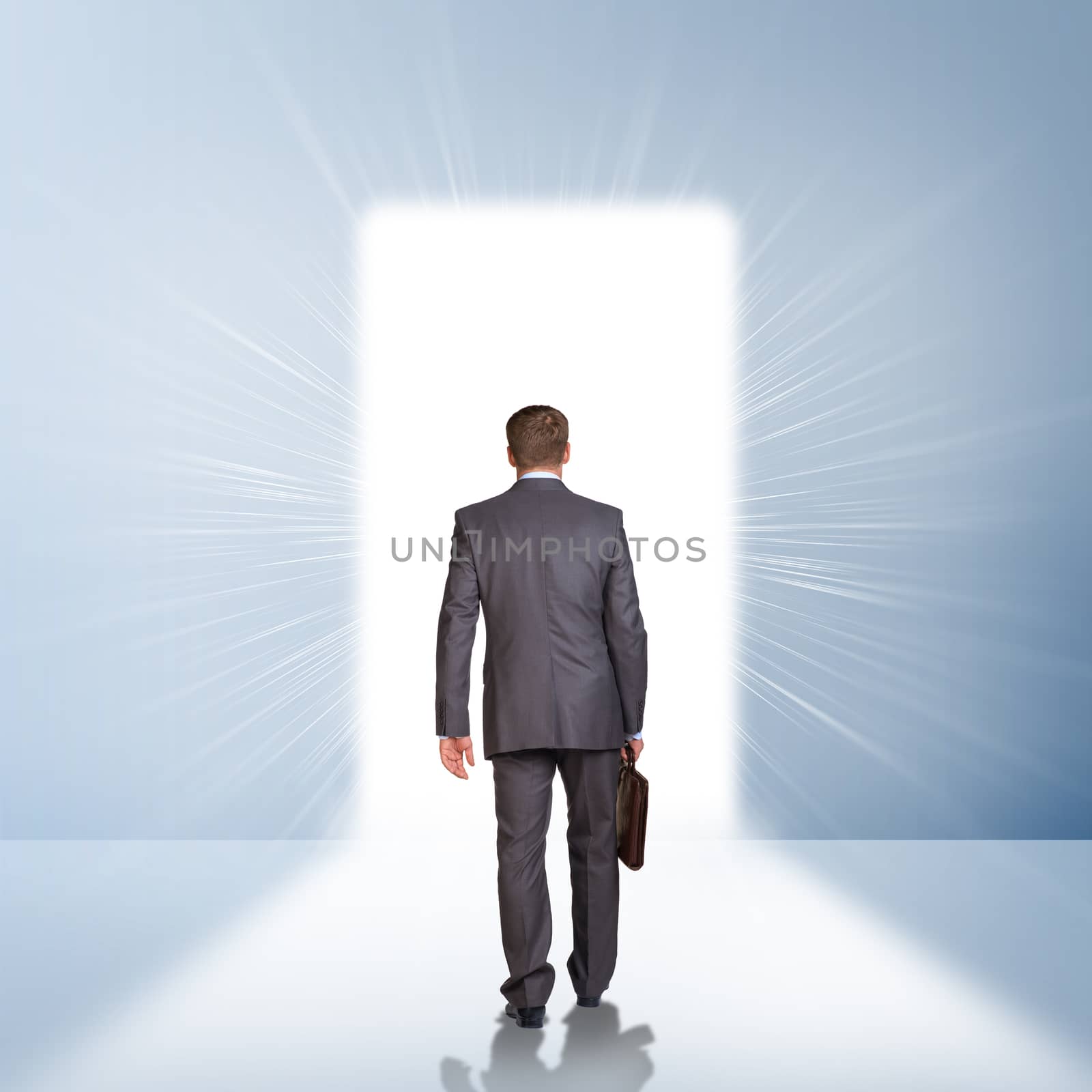 Businessman in suit with briefcase stepping through door. Business concept