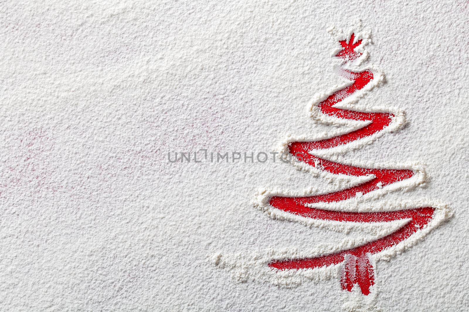 Christmas tree on flour background. White flour looks like snow. Top view