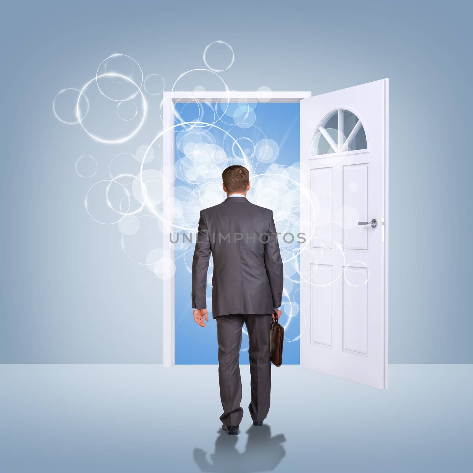 Businessman in suit with briefcase stepping through door. Sky as backdrop. Business concept