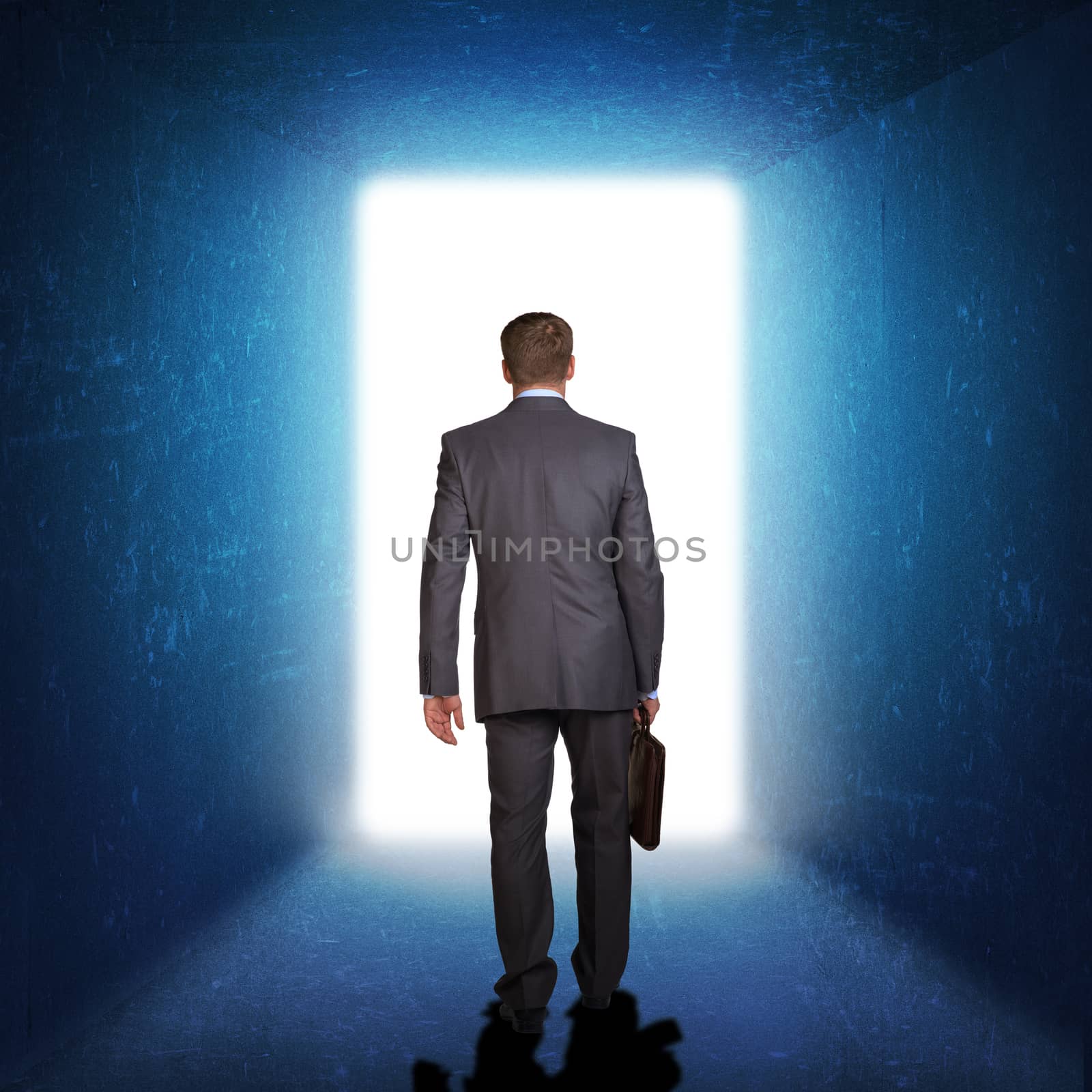 Businessman in suit with briefcase stepping through door. Business concept