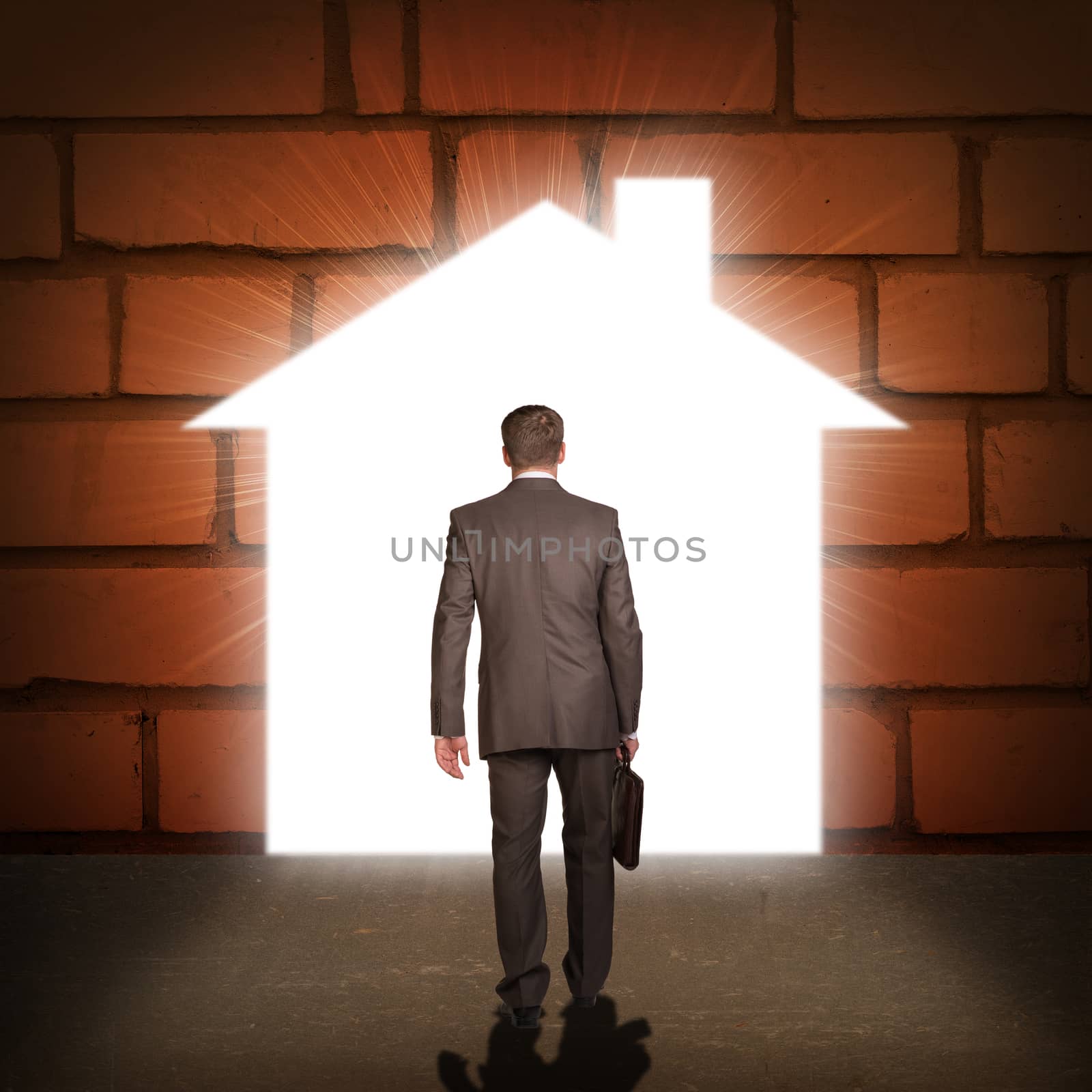 Businessman in suit with briefcase stepping through door in form of house. Business concept