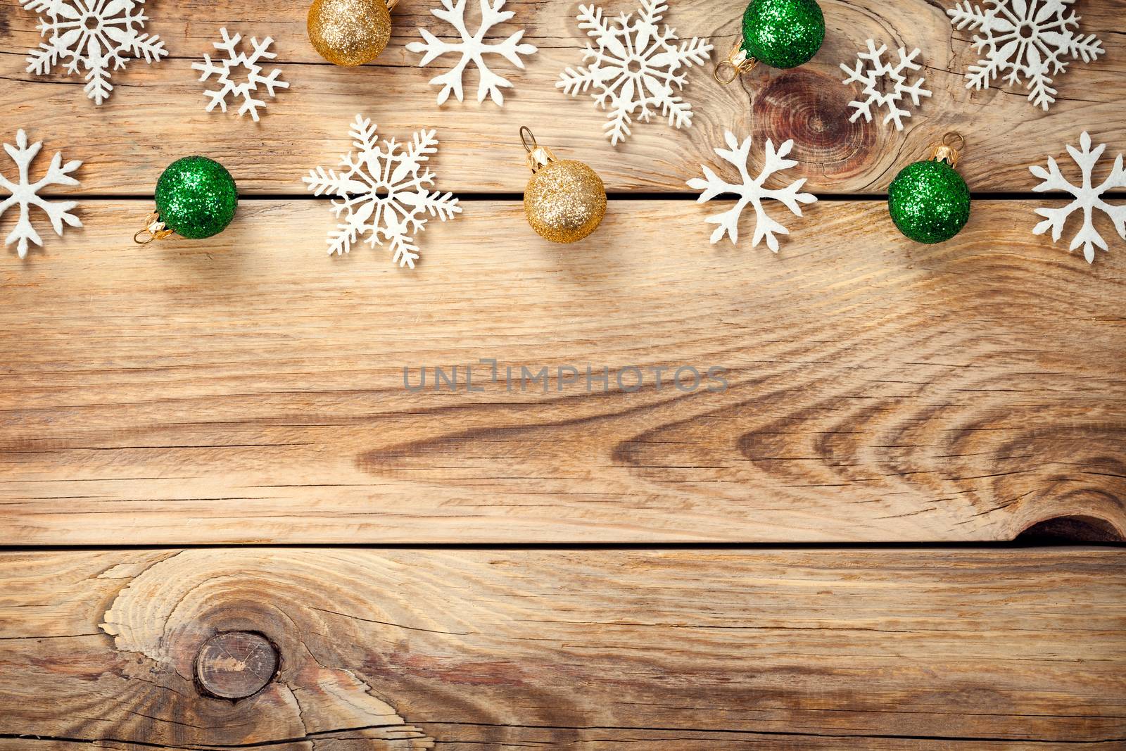 Christmas background with snowflakes and christmas balls on wooden table. Copy space. Top view