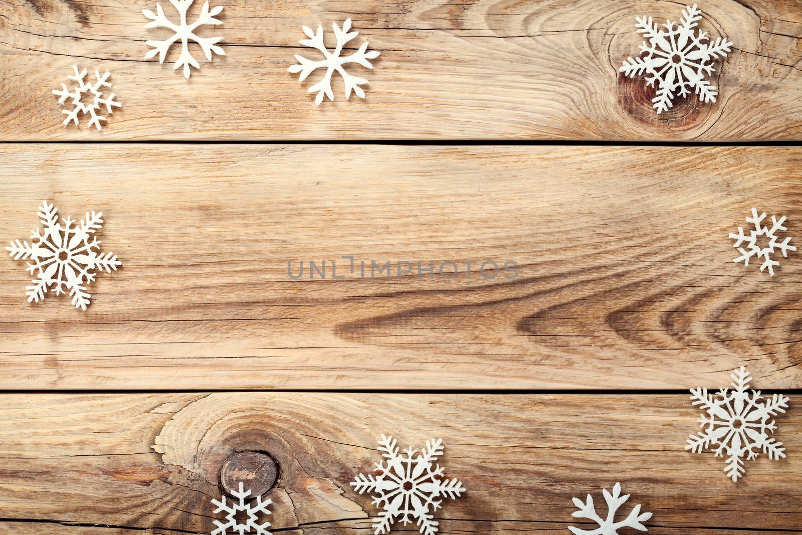 Christmas background with snowflakes on wooden table. Copy space. Top view