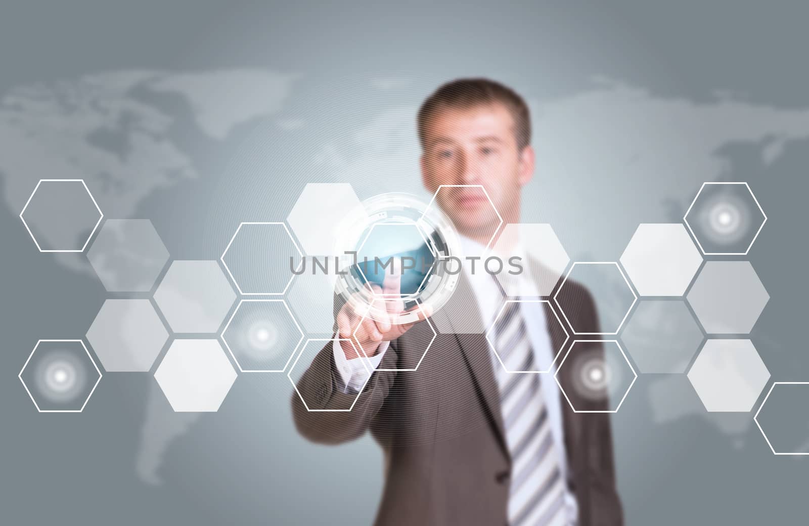 Businessman in suit finger presses virtual button. Transparent hexagons, world map as backdrop