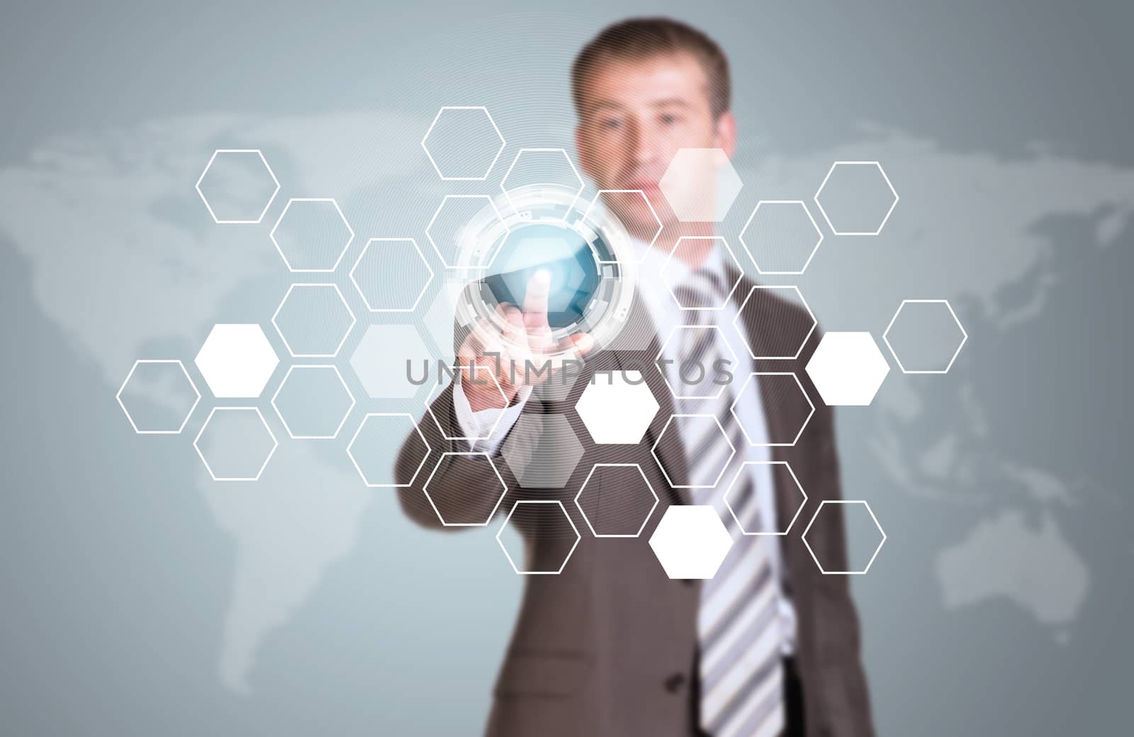 Businessman in suit finger presses virtual button. Transparent hexagons, glow circles and world map as backdrop
