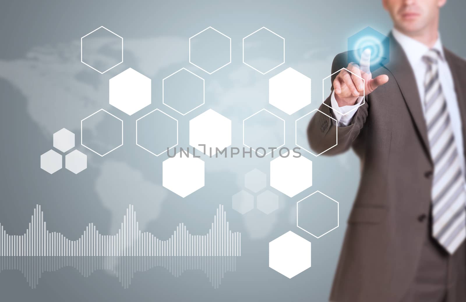 Businessman in suit finger presses virtual button. Hexagons, world map and graphs as backdrop