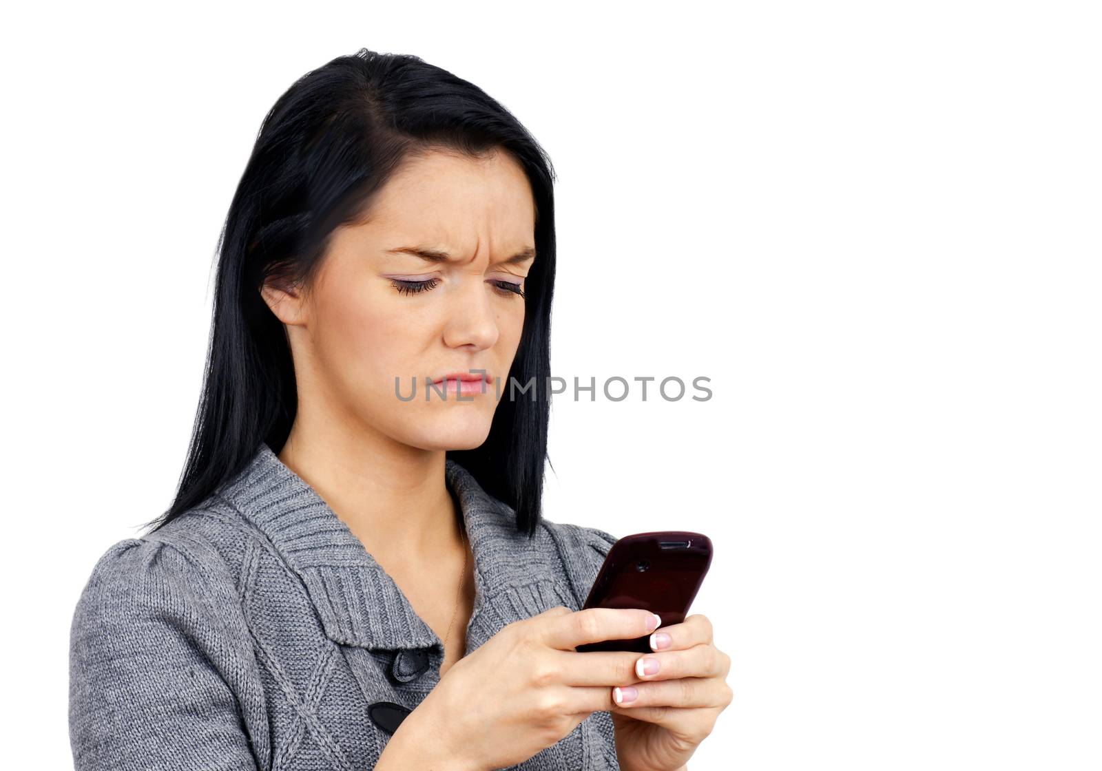 Young woman with cell phone unhappy with selfie or text