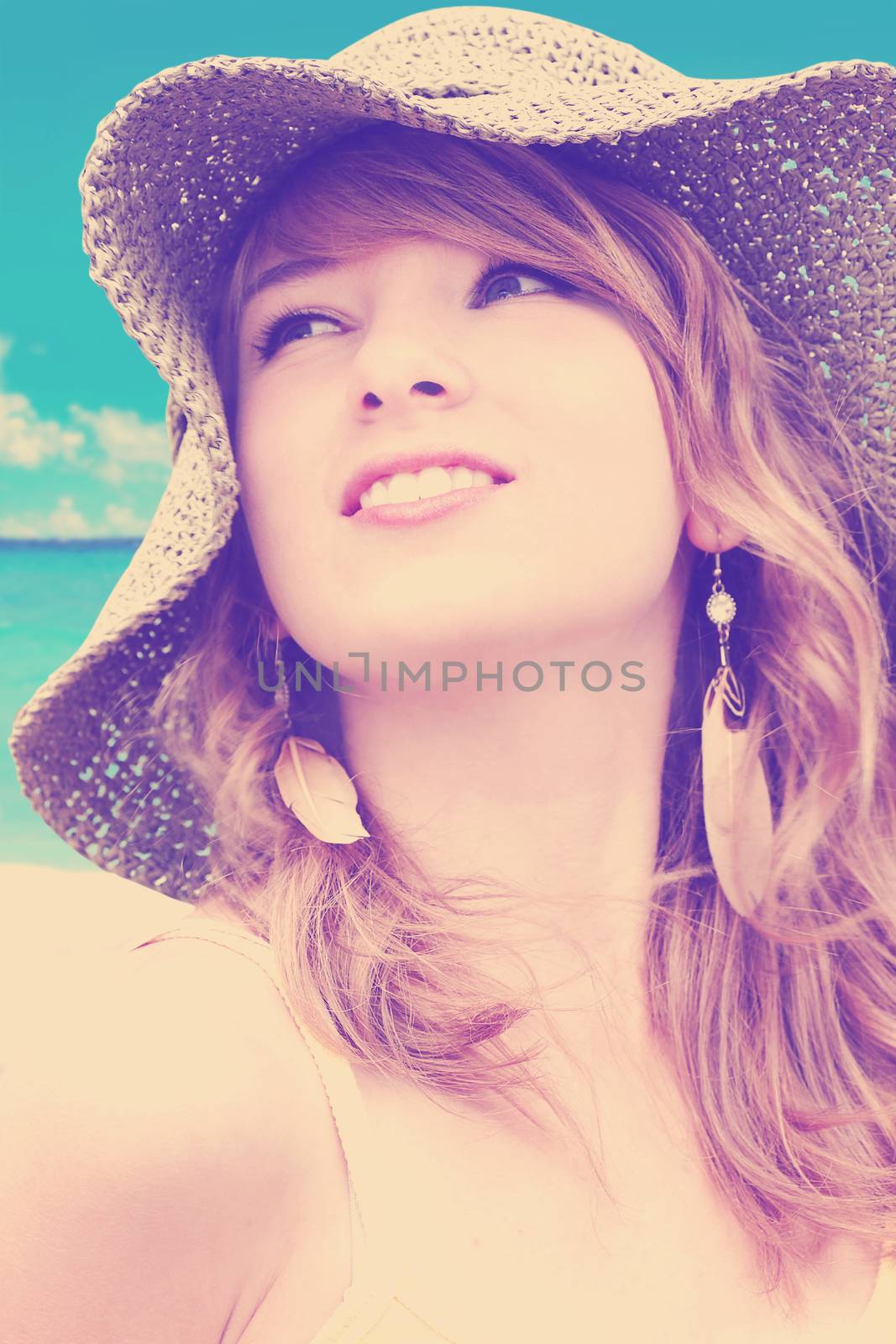 Beautiful young blond woman with large straw sun hat - color filters