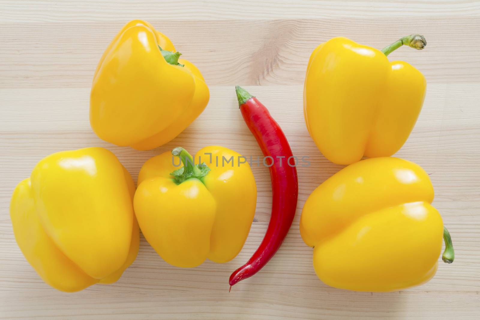five sweet yellow paprika and one red hot chili pepper