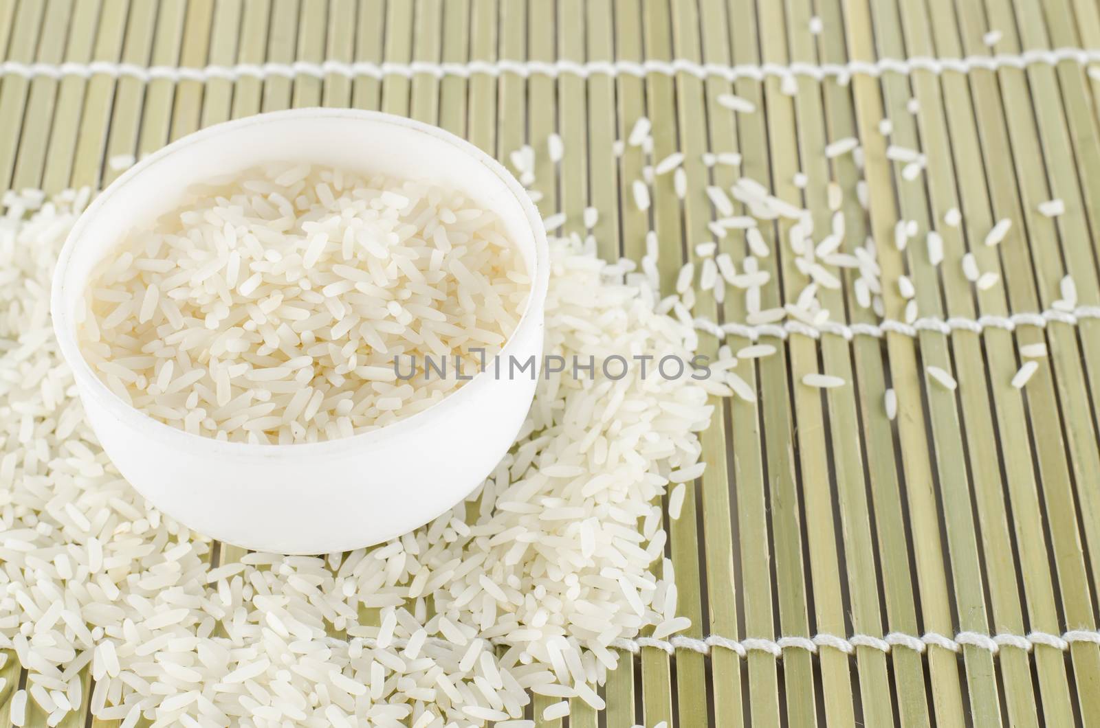 uncook rice in mini bowl on wooden pad
