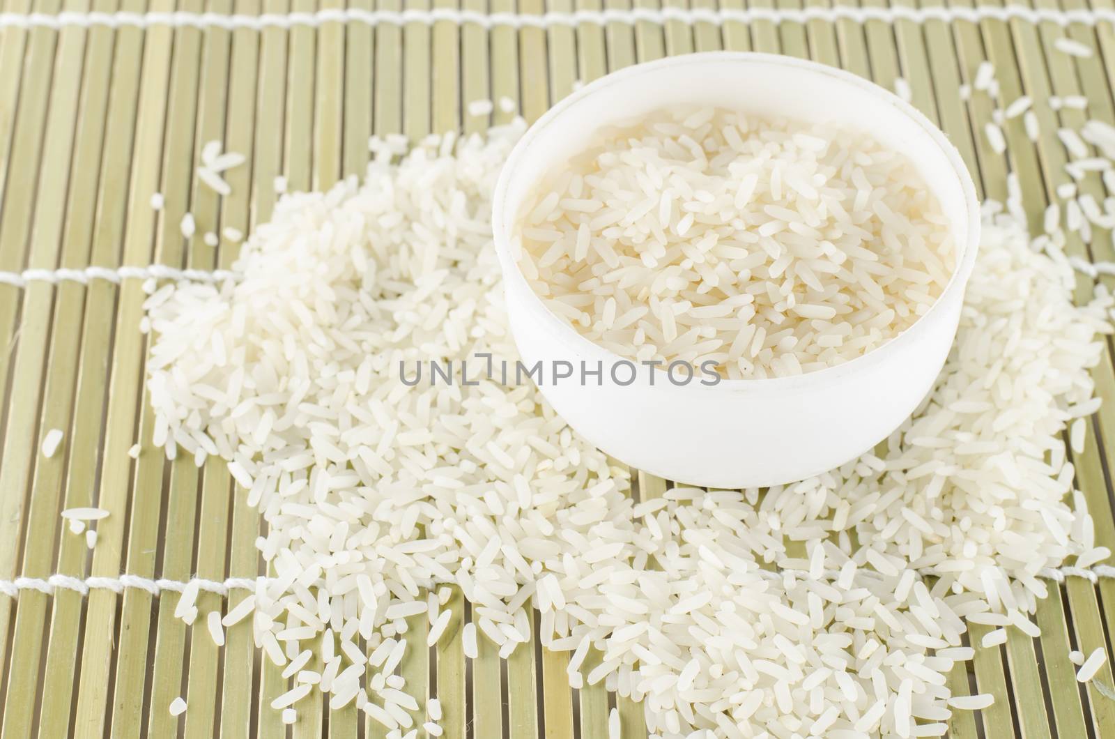 uncook rice in mini bowl on wooden pad