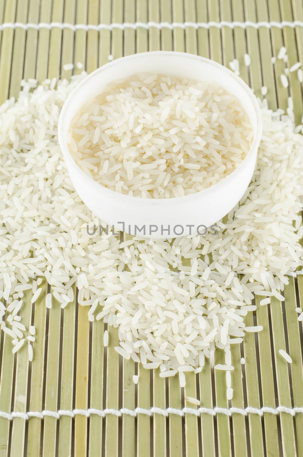 uncook rice in mini bowl on wooden pad