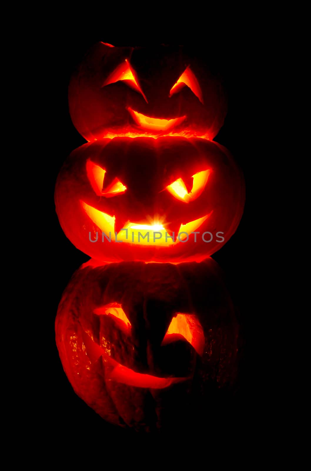 Illuminated cute halloweens pumpkin isolated on black background