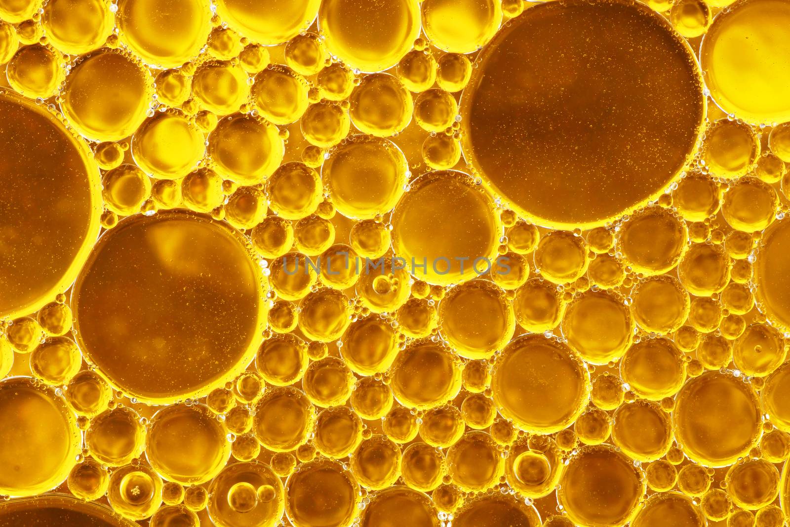 Oil drop and water over gole and yellow tones background-fun abstract