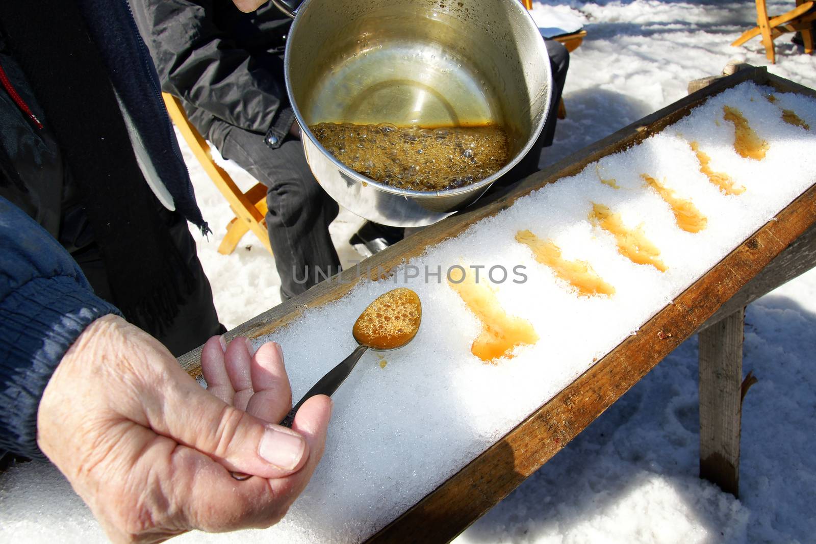 Making sugar on snow, or maple toffee at the sugar shack in Quebec, Canada
