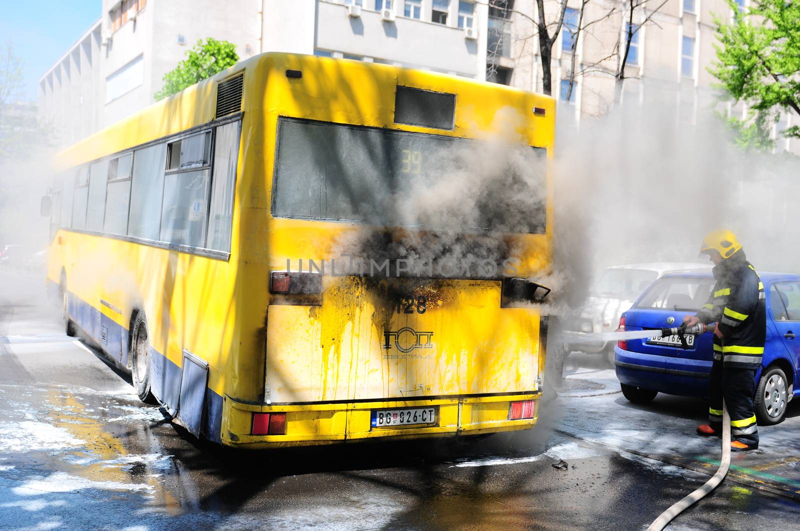 SERBIA, BELGRADE - APRIL 27, 2012: Bus on fire on the street in the middle of the day. More than have of the buses in Belgrade are older than 10 years