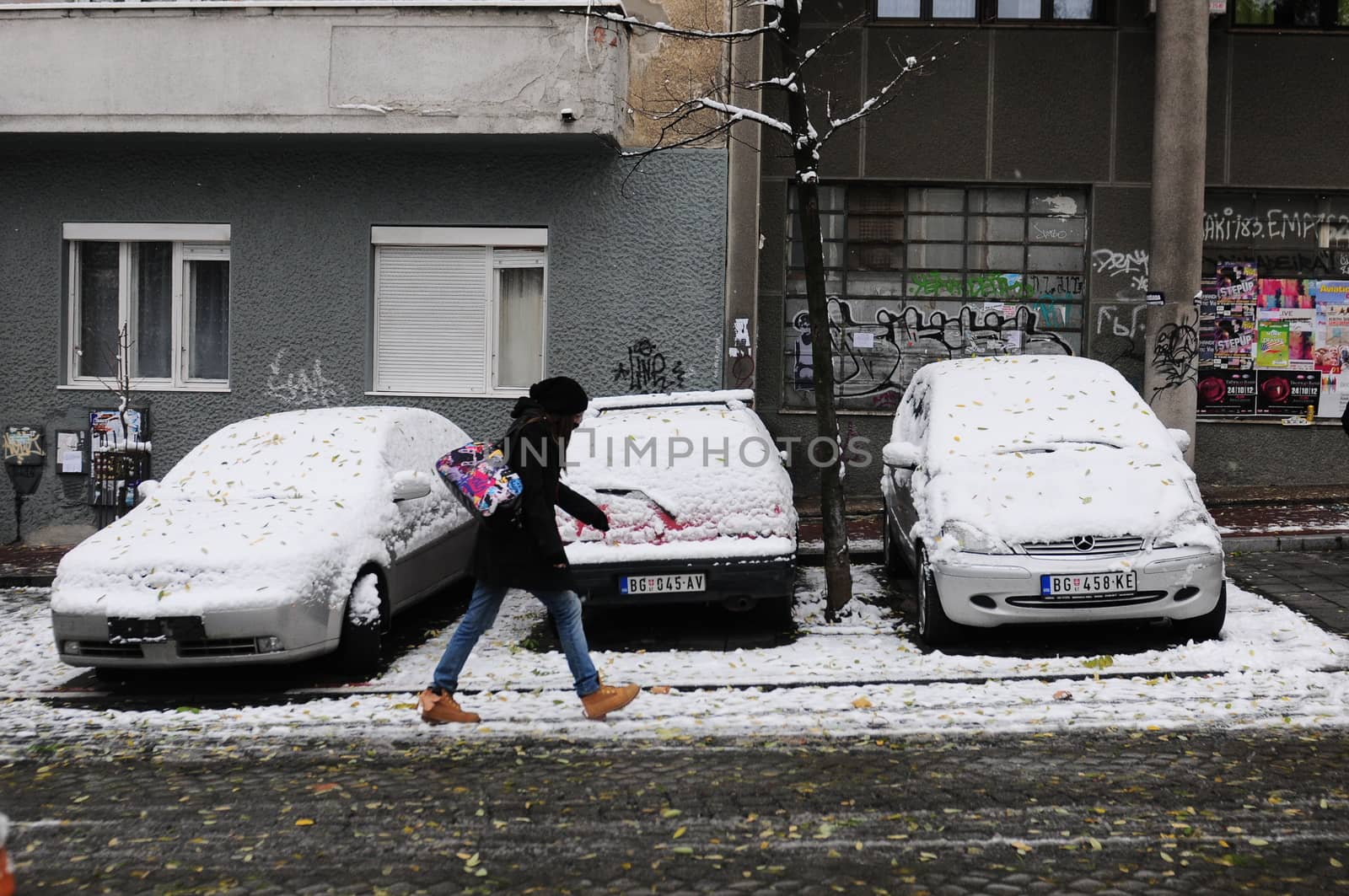 SERBIA, BELGRADE - DECEMBER 8, 2012: Girl walking through the city, paralisied by unexpectable massive snowfall. During weekend only small number of snow services are working