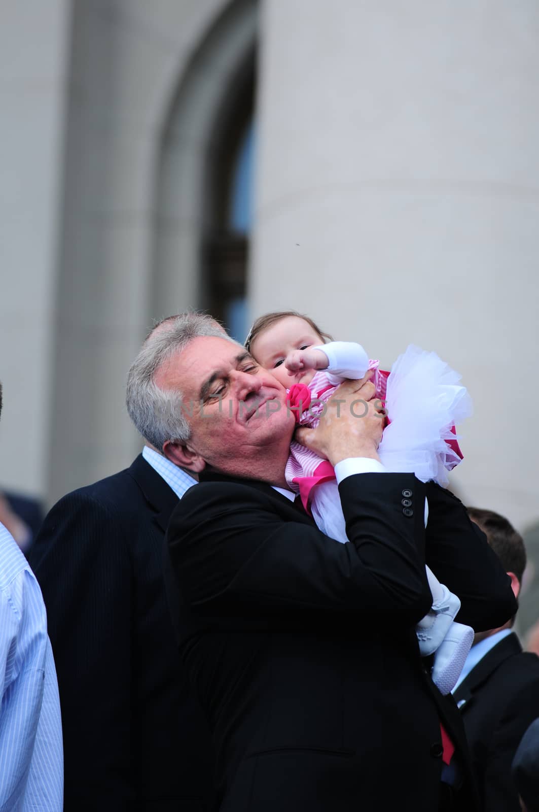 SERBIA, BELGRADE - MAY 31, 2012: President of Serbia Tomislav Nikolich holding his granddaughter high in the air on his inauguration day