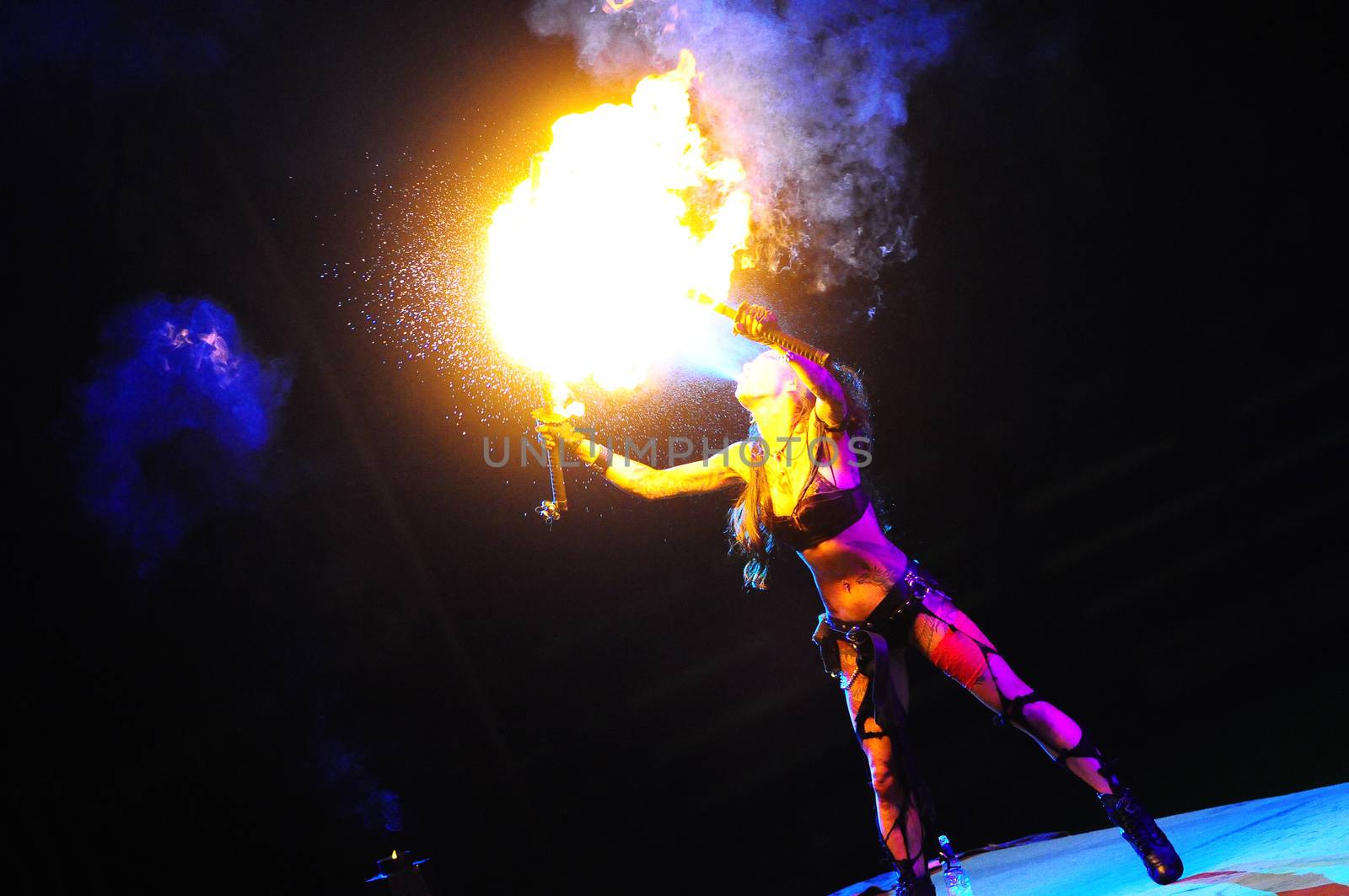 SERBIA, BELGRADE - APRIL 26, 2012: Sexy girl lighting a torch during Masters of dirt show, most thrilling and spectacular freestyle motocross show