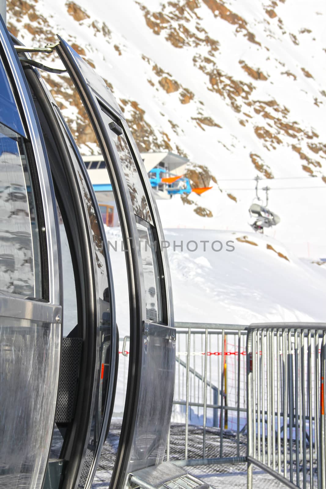 Ski lift chairs on bright winter day in Alp mountains