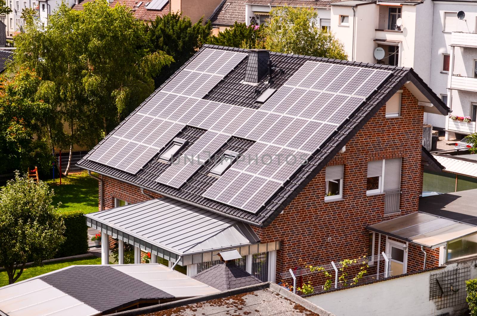 Green Renewable Energy with Photovoltaic Panels on the Roof.