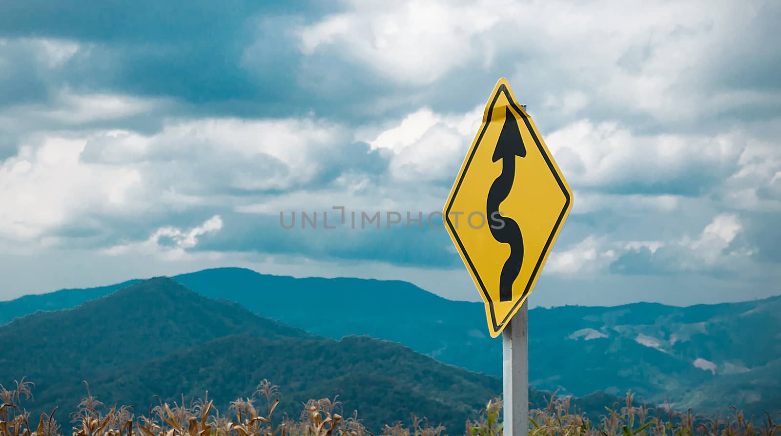 The Curve Traffic Sign Blur Landscape Background.