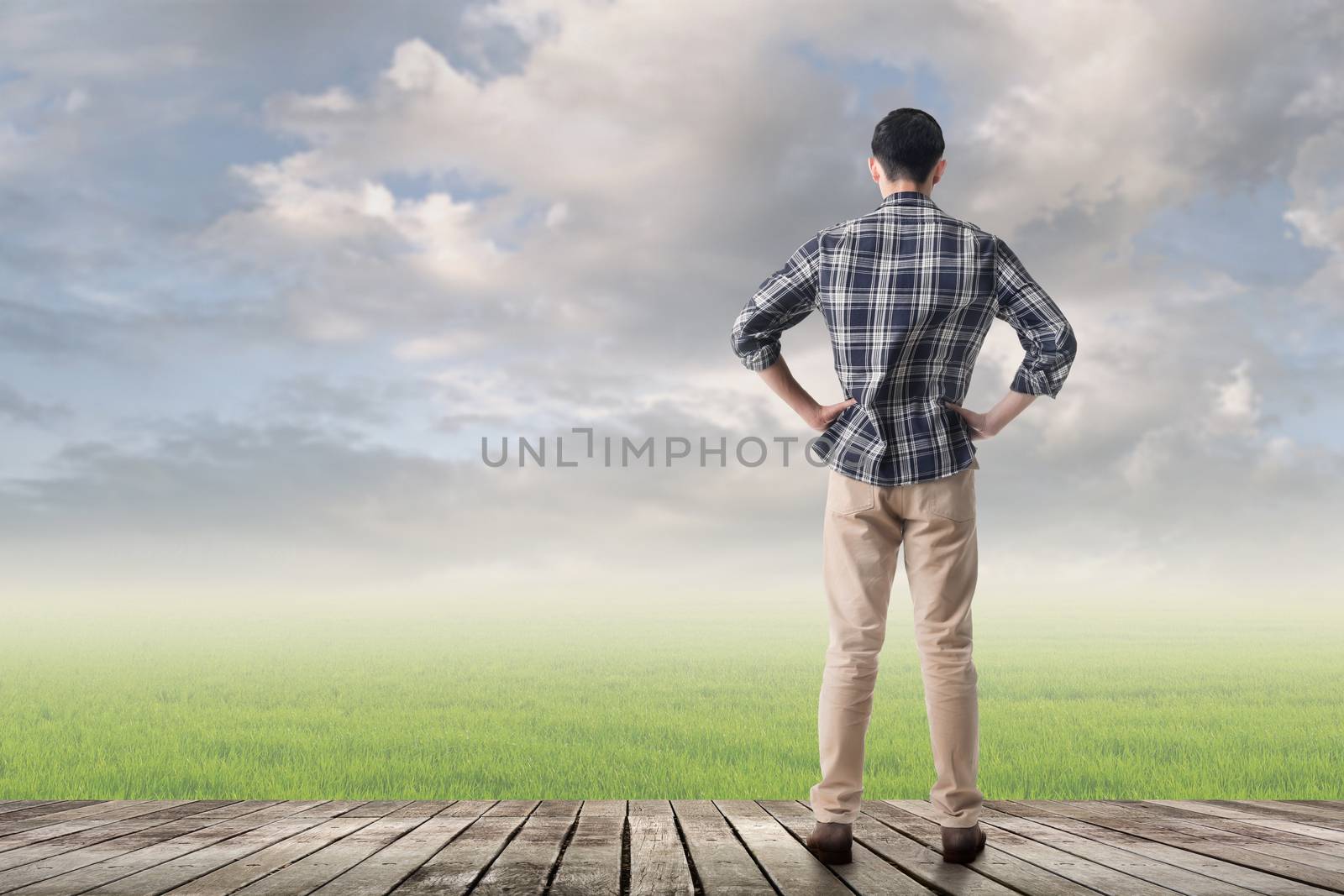Asian man against grassland with copyspace.