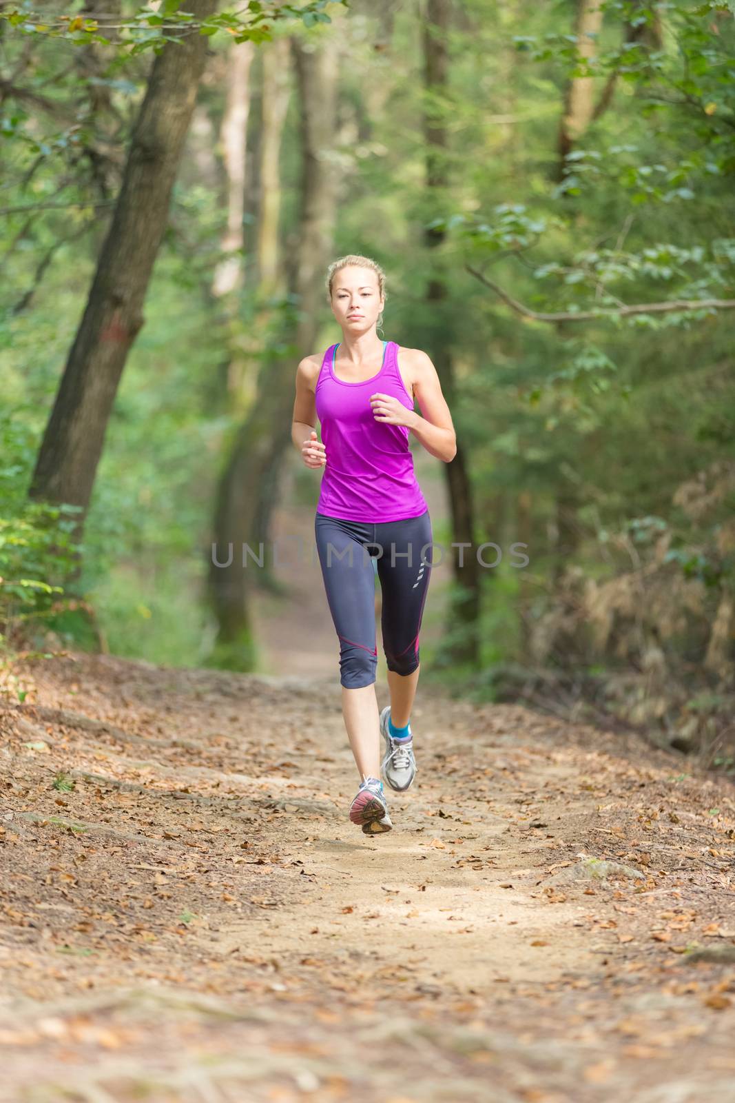 Pretty young girl runner in the forest.  by kasto