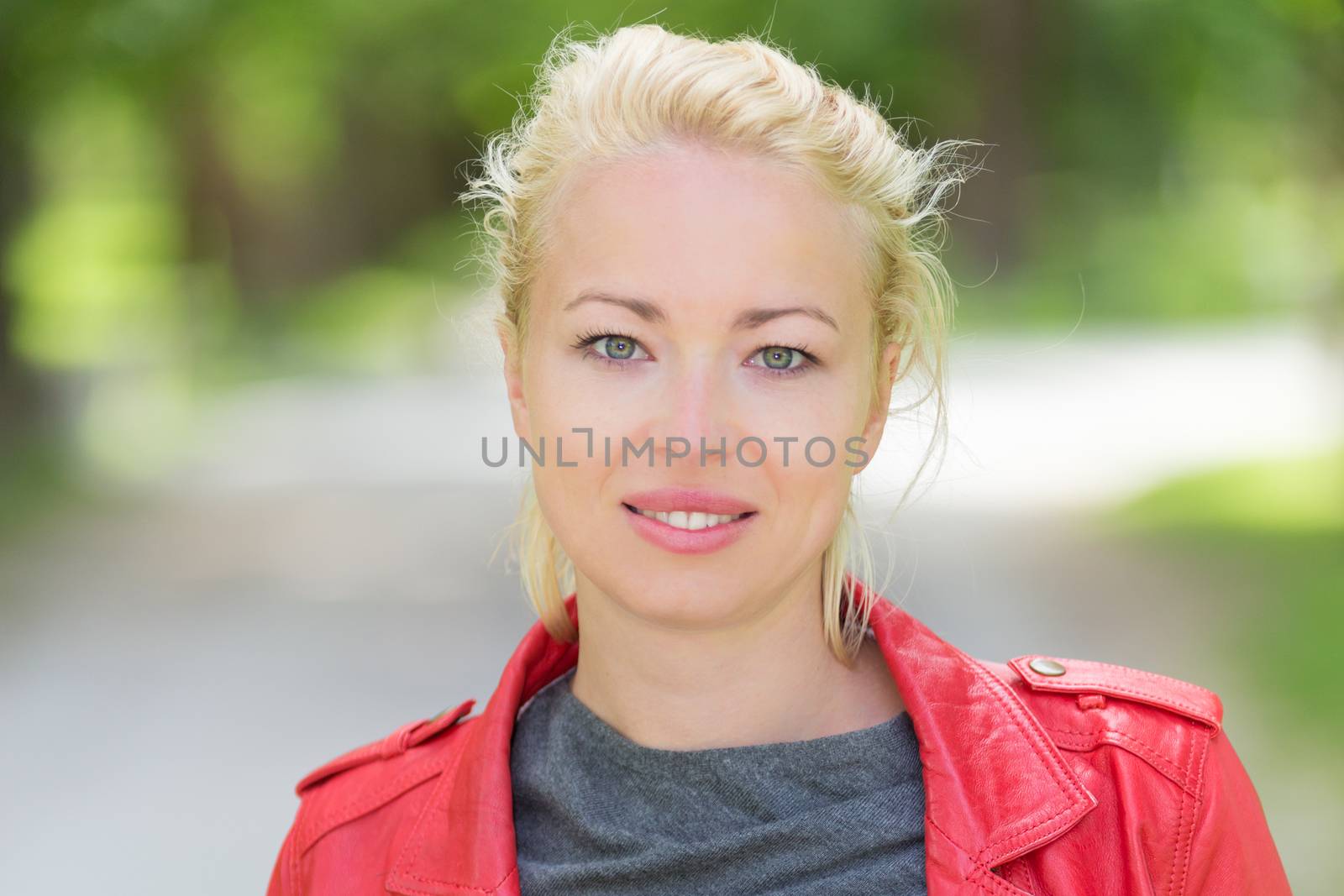 Portrait of happy young woman in the park.