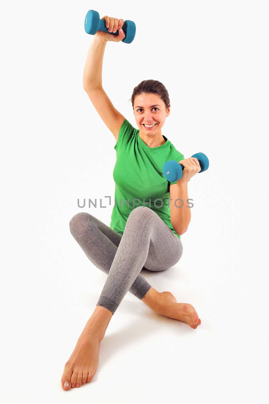 portrait of pretty sporty girl holding weights