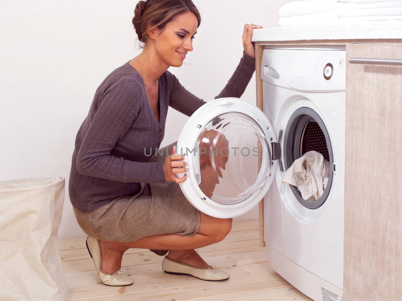 Housework, young woman doing laundry