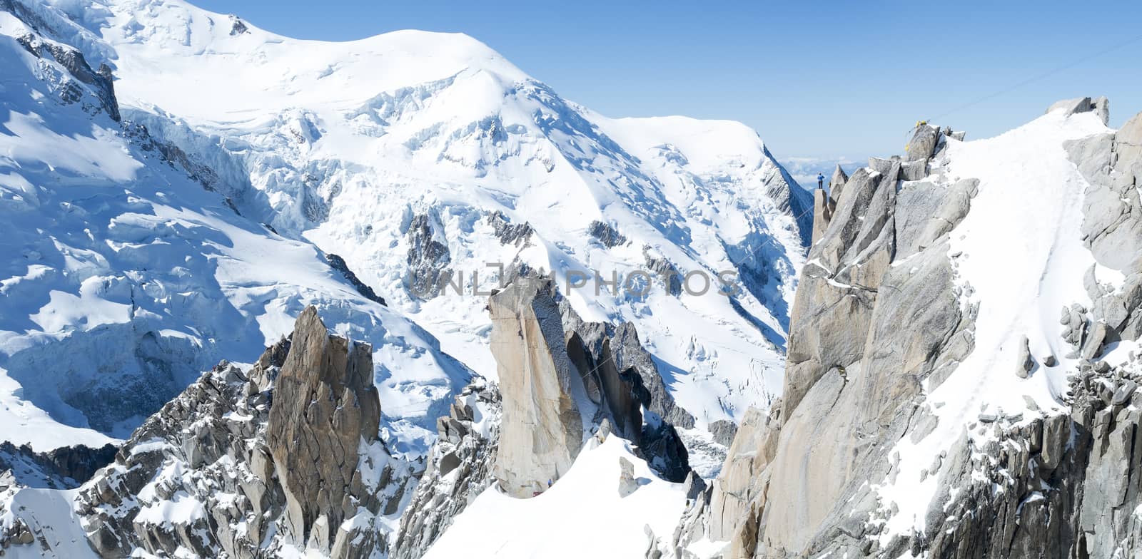 Panoramic composite of Mont Blanc mountain range, In Chamonix, France, with climbers on its rocks