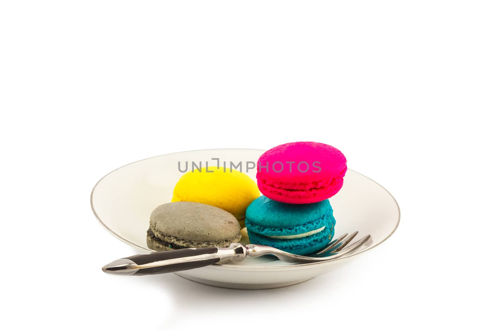 Macaroons with fork on glass plate