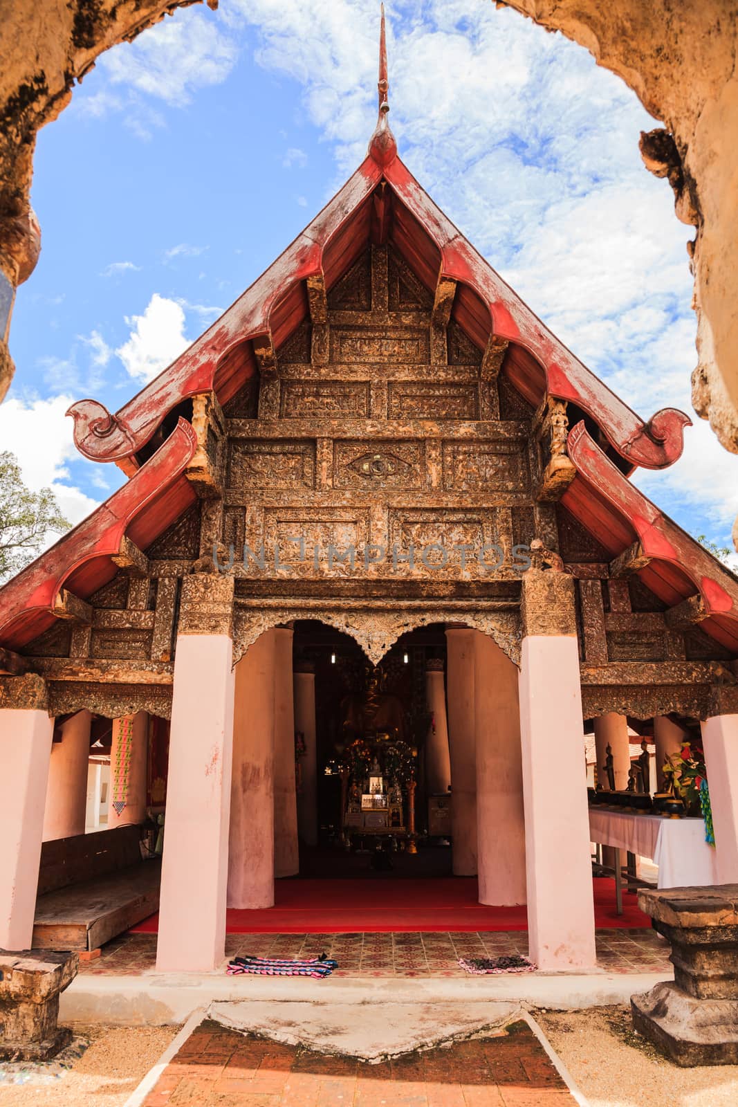 Ancient viharn of lanna style temple with the very beautiful carving decoration on the facade