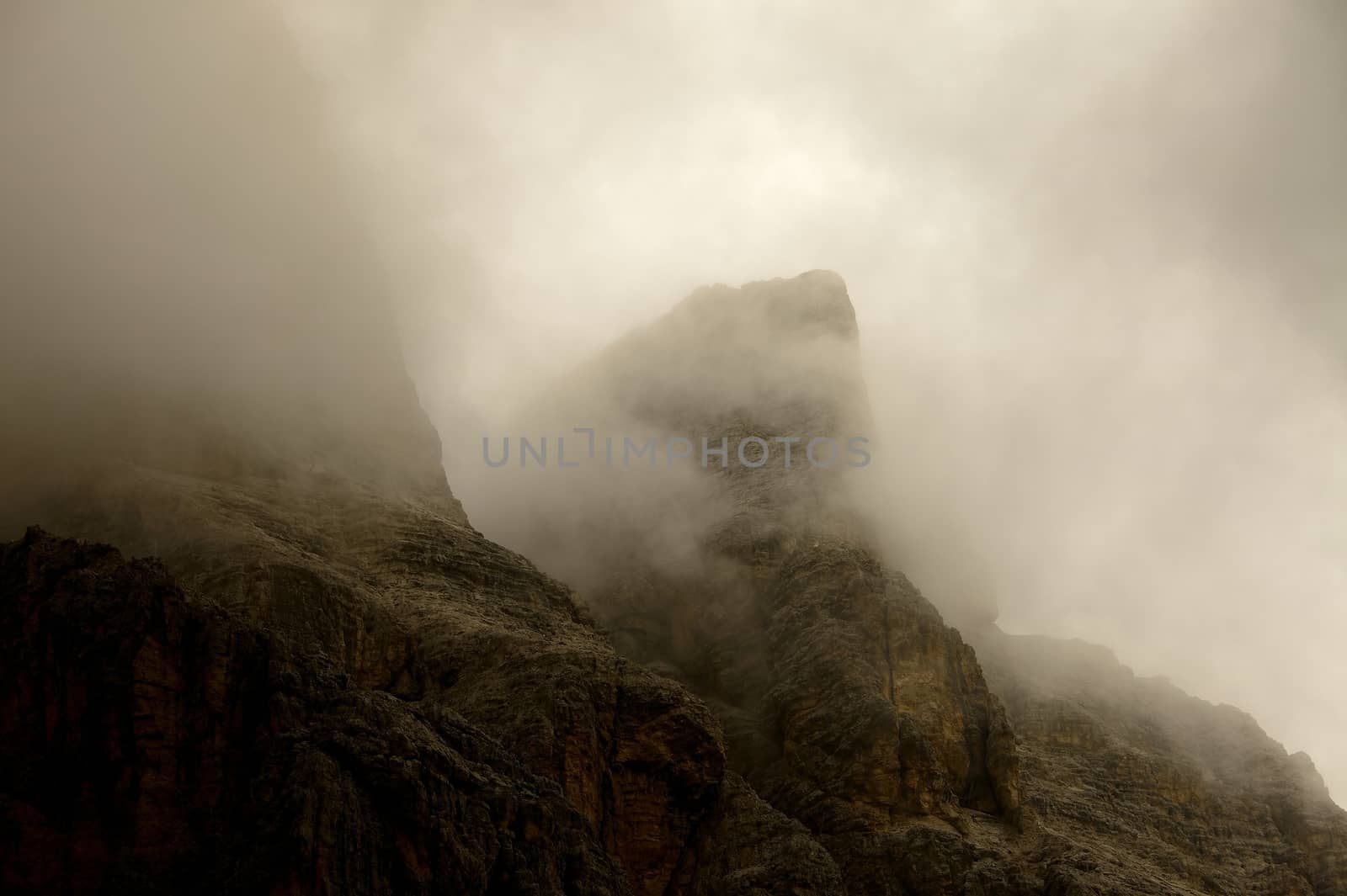 High mountain ridge in thick fog